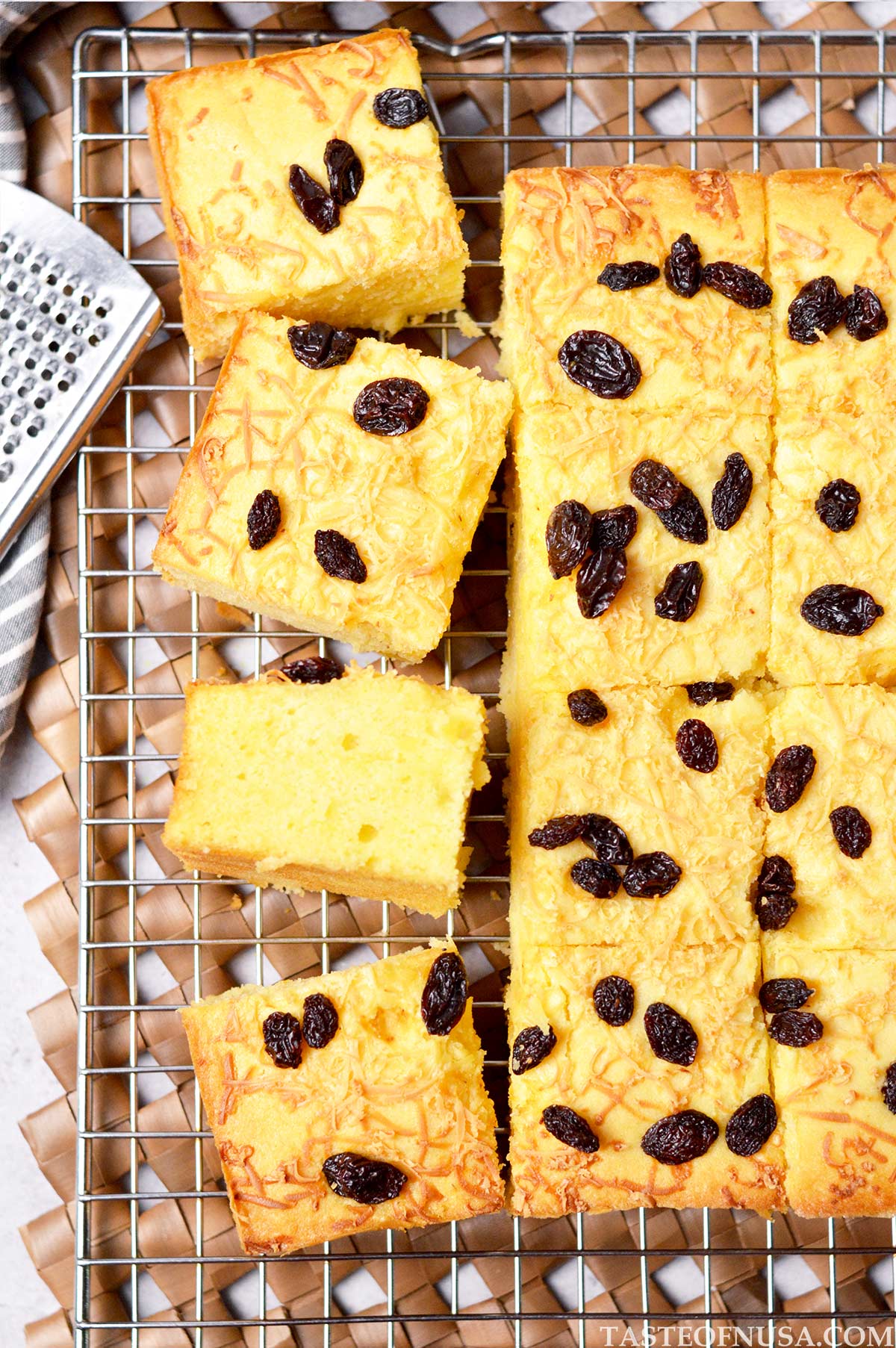 cassava tapai cake (bolu tape) with grated cheddar cheese and raisins