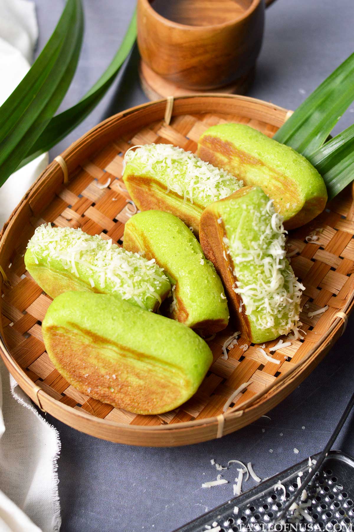 indonesian pandan kue pukis or pukis cake with grated cheddar cheese topping