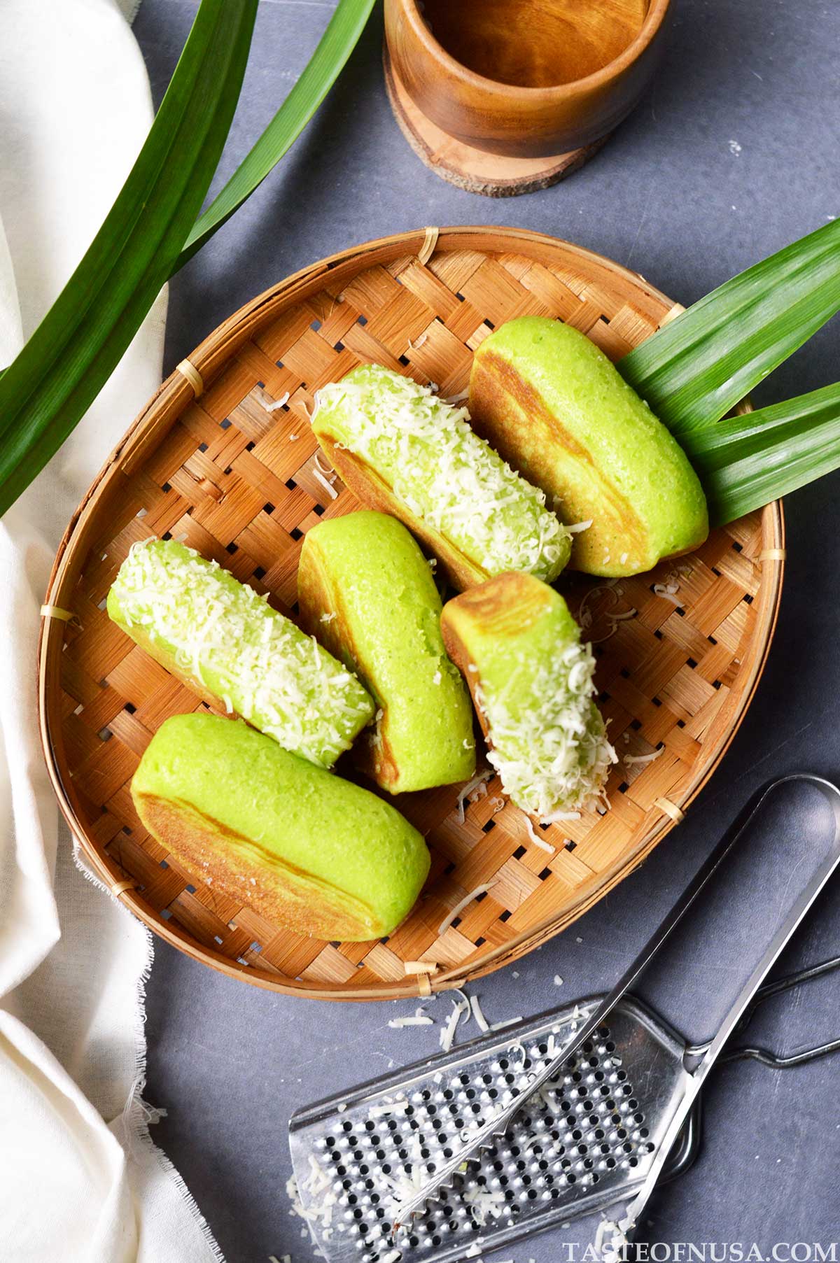 indonesian pandan kue pukis or pukis cake with grated cheddar cheese topping