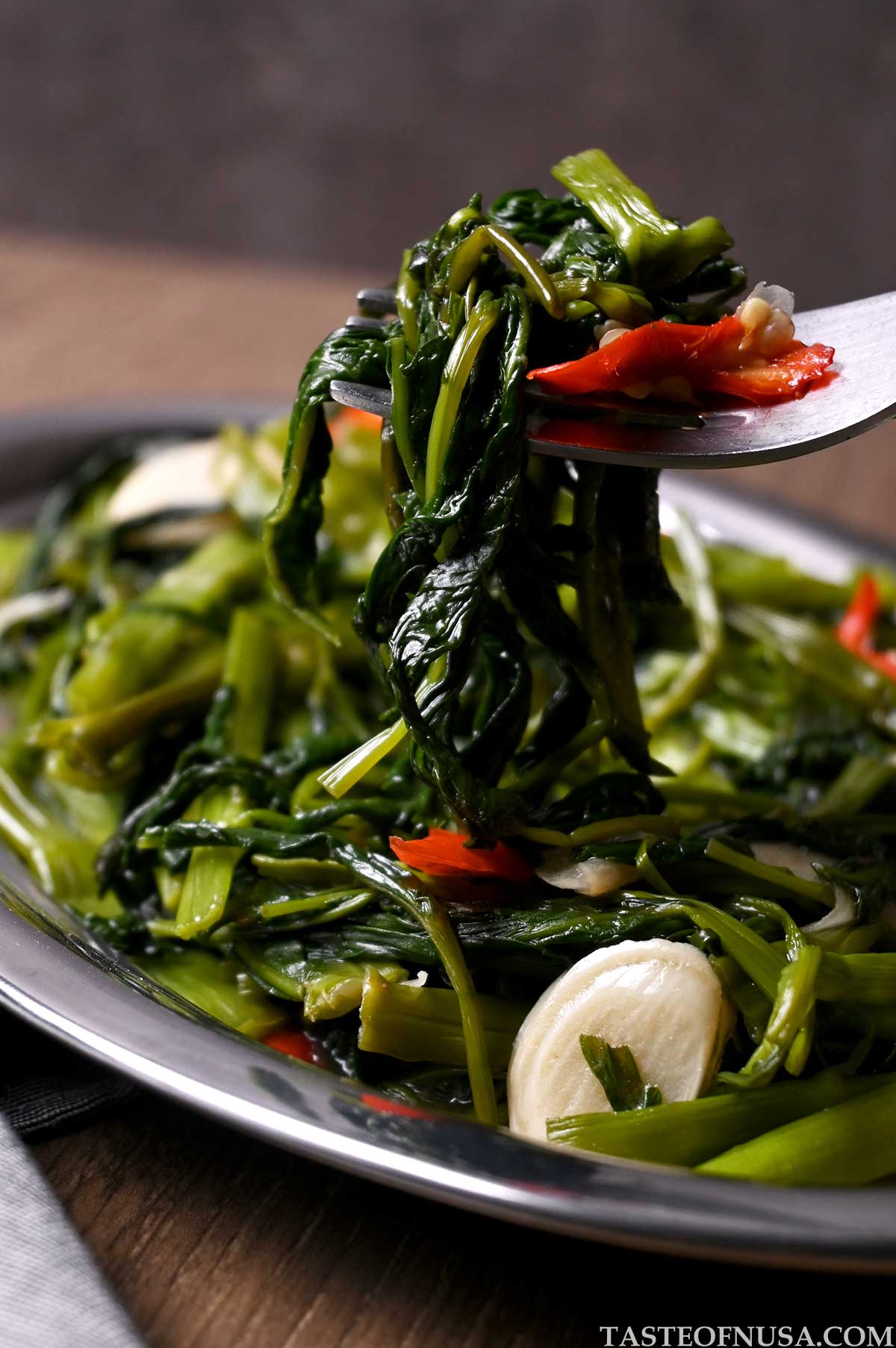 morning glory or water spinach stir fry cooked with shallots, garlic, and oyster sauce