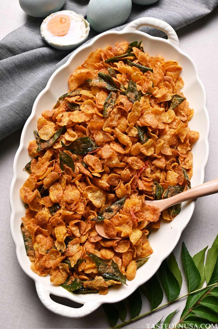 crispy salted egg yolk cornflakes with bird's eye chilis and curry leaves